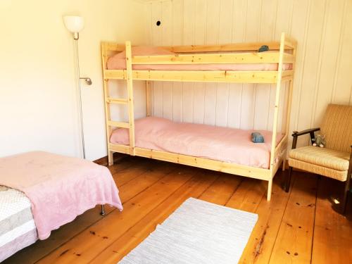 a room with two bunk beds and a chair at Pilgrim 