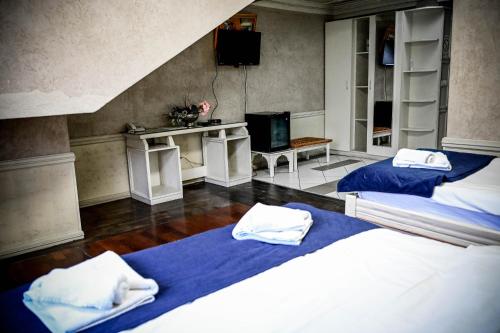 a bedroom with two beds with towels on them at Hotel Centar Balasevic in Belgrade