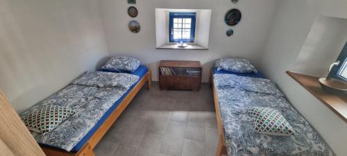 a room with two beds and a window at Apartma Aria&Karra in Komen