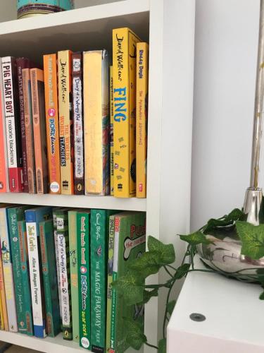 a book shelf filled with lots of books at Spacious 3 bed townhouse in Dublin 12 in Dublin