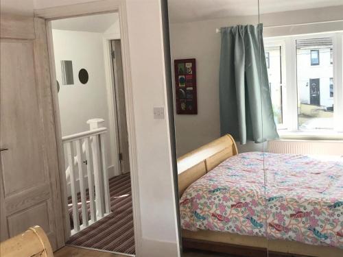 a bedroom with a bed and a window and a mirror at Spacious 3 bed townhouse in Dublin 12 in Dublin