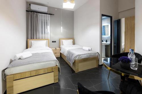 a hotel room with two beds and a table at EVN Rooms in Yerevan