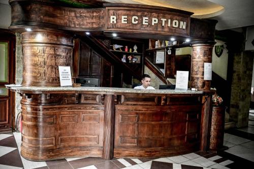 a man sitting at a bar in a restaurant at Hotel Centar Balasevic in Belgrade