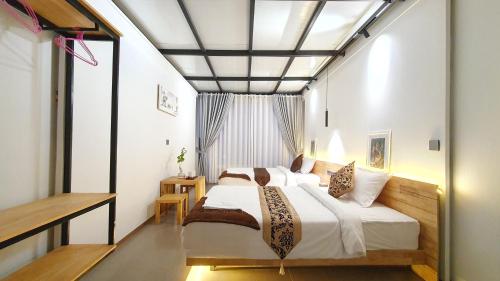 a bedroom with a large bed and a window at Cool Home Office, Sihanoukville in Sihanoukville