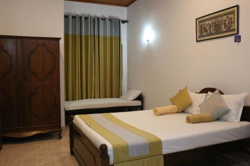 a bedroom with a bed and a chair in it at Xotic Resort Upper Floor in Kurunegala