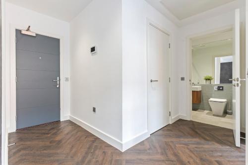 a white bathroom with a toilet and a sink at Birmingham City Centre Serviced Apartment - Celestial Lettings in Birmingham