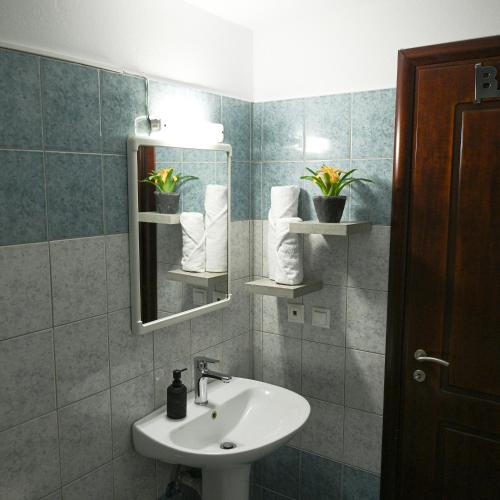 a bathroom with a sink and a mirror at Silkes Apartment in Sitia