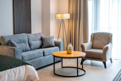 a living room with a couch and a chair and a table at Dve Kule Resort & Winery in Bačinci
