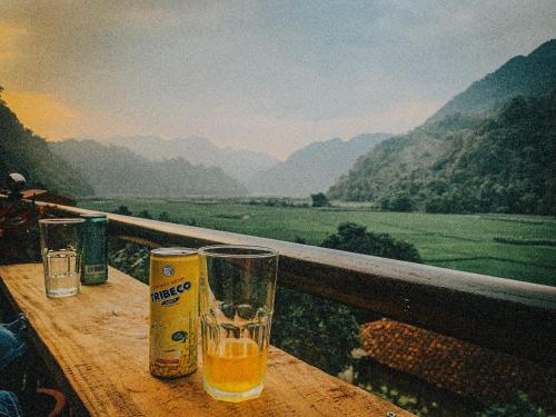 a glass on a table with a view of a valley at Duy Tuyen Ba Be Homestay in Bak Kan