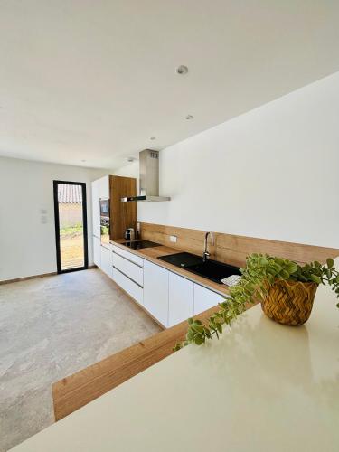 a kitchen with a sink and a counter top at Villa du grangeon in Rosières