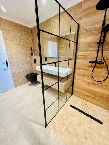 a room with a glass wall with a bed in it at Villa du grangeon in Rosières