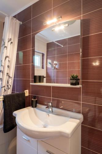 a bathroom with a sink and a mirror at Apartment Wish - two bedrooms with 2 AC renewed in Pag