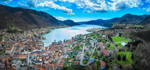 an aerial view of a city next to a river at Lakes and Mountains Magic Holiday House in Omegna