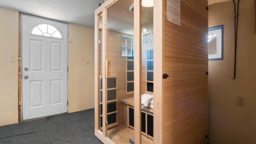 a room with a closet with a wooden wall at Governor's Mansion beautiful 3bd with pool table in Leadville