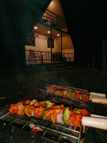 a bunch of food is cooking on a grill at IInfinity Kodaikanal in Kūkkāl