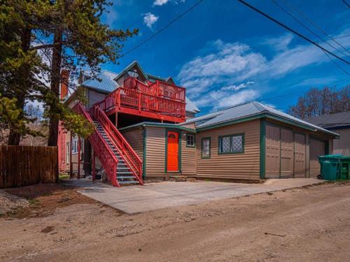 a house with a red staircase on top of it at Historic Loft on top of The Governor's Mansion in Leadville
