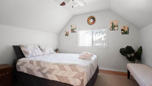 a bedroom with a bed and a window at 1880s Victorian Remodel - 1 2 block from downtown in Leadville