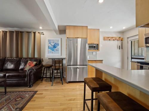 a kitchen and living room with a stainless steel refrigerator at Relaxing 2 Bedroom steps from Vail Resort in Vail