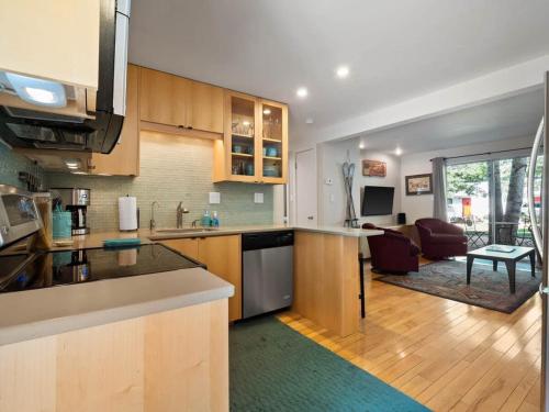 a kitchen with a counter and a living room at Relaxing 2 Bedroom steps from Vail Resort in Vail