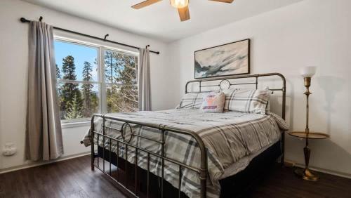 a bedroom with a bed and a large window at Mountain Home with Amazing Views and Hot Tub in Leadville