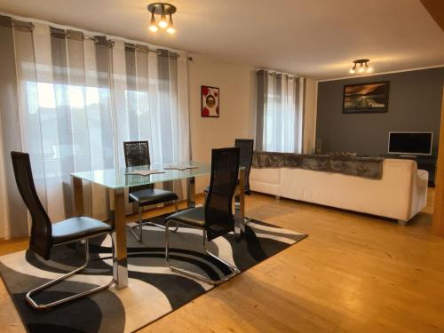 a dining room with a table and chairs and a couch at Hotel-Restaurant-Haus Berger in Viersen