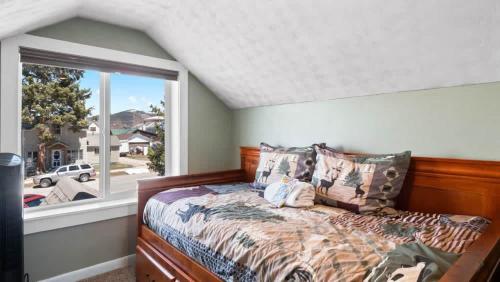 a bedroom with a bed and a large window at Mom's House - 1 block from downtown & Hot Tub in Leadville
