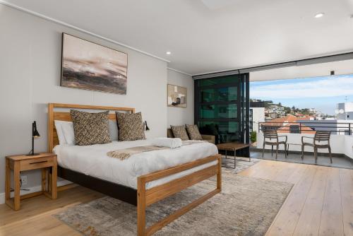 a bedroom with a bed and a balcony at 7 on Bantry Apartments in Cape Town