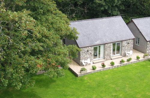 an aerial view of a stone house with a yard at The Old Farmhouse B&B in Dyffryn