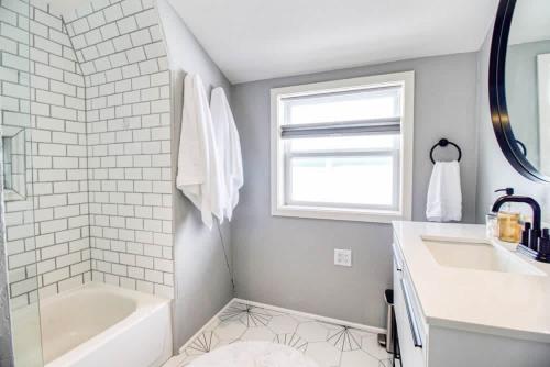 a bathroom with a white tub and a sink and a bath tubermott at Leadville Dairy Flat - 2 Bed with Office and HOT TUB in Leadville