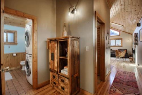 a bathroom with a washer and dryer in a house at Little Lodge Leadville: charming 2bd in Leadville