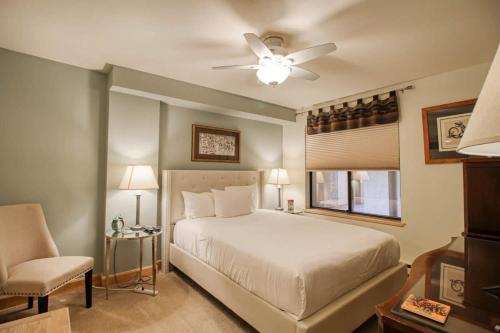 a bedroom with a bed and a ceiling fan at Unit 520 - 3br condo with balcony views in Avon