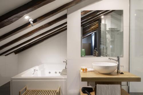a bathroom with a white sink and a mirror at Petit Palace Plaza del Carmen in Madrid