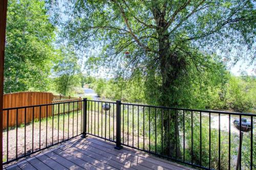 a balcony with a fence and a tree at Modern 3bd cabin in Edgewater in Granby