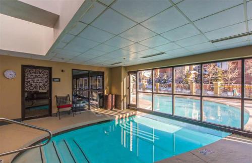 a swimming pool with a large window in a hotel room at 1bd 272 Perfect Location with Pool in Crested Butte