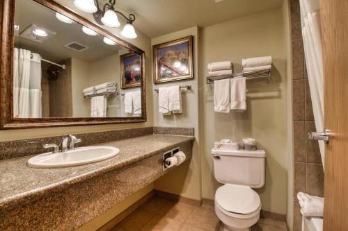 a bathroom with a sink and a toilet and a mirror at NEW Listing Perfect Location 414 with Heated Pool and Hot Tub in Crested Butte