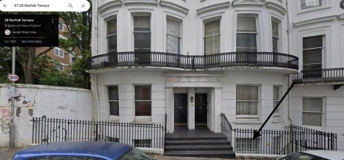 a white building with a balcony on top of it at Oasis studio in the Heart of the City in Brighton & Hove