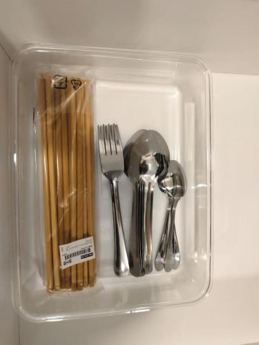 a plastic container filled with utensils and chopsticks at MUJI Cosy Level 25th Room Amber Residence @ Quayside Mall Rimbayu Near to Masha Oasis Tenby KLIA Kota Kemuning in Teluk Panglima Garang