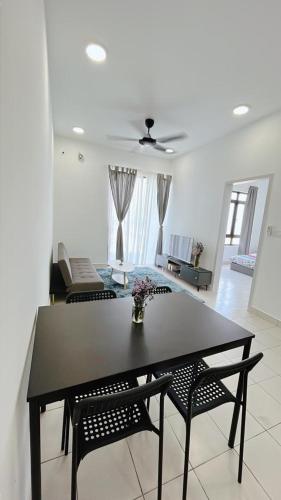 a dining table and two chairs in a living room at MUJI Cosy Level 25th Room Amber Residence @ Quayside Mall Rimbayu Near to Masha Oasis Tenby KLIA Kota Kemuning in Teluk Panglima Garang