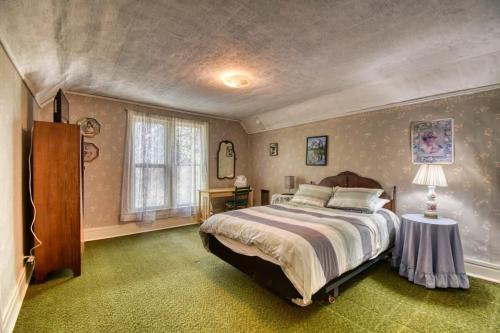 a bedroom with a large bed and a window at The Victorian Aspen Grove- 2bd w Sauna & Gym in Leadville