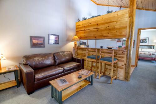 a living room with a leather couch and a table at Lackawanna 1A in Leadville
