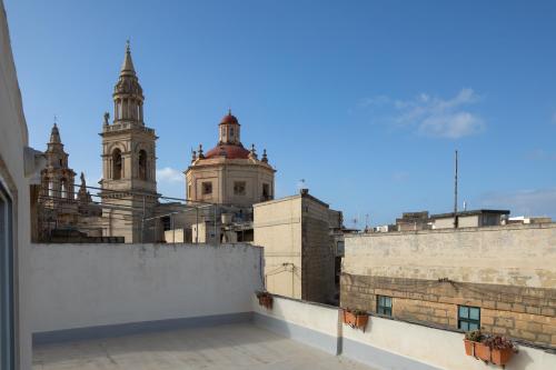 a view from the roof of a building with two towers at Family-Friendly Spacious Townhouse with Garden - Close to Airport in Gudja