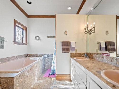 a bathroom with two sinks and a tub at Painted Lady in Leadville