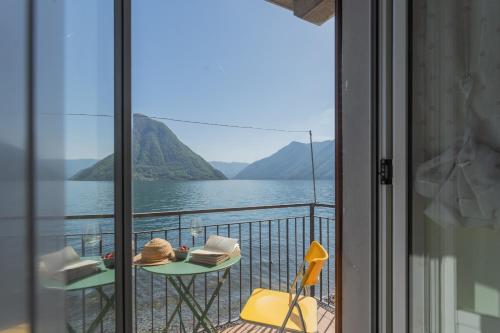 a balcony with a view of a lake and mountains at Il Timone by Rent All Como in Colonno