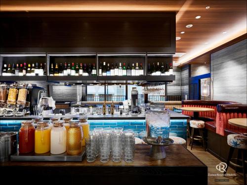 a bar with many bottles of drinks on a table at Daiwa Roynet Hotel Nishi-Shinjuku PREMIER in Tokyo