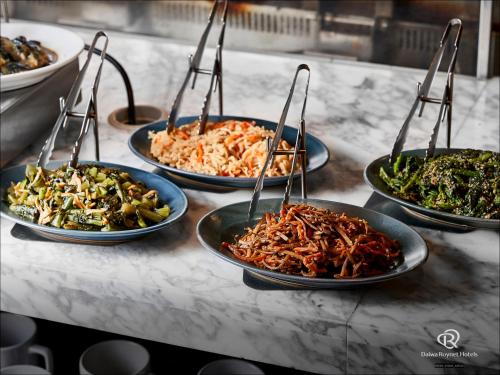 a group of plates of food on a counter at Daiwa Roynet Hotel Nishi-Shinjuku PREMIER in Tokyo