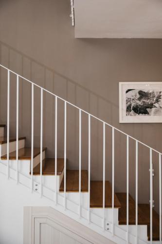 a white staircase with two beds in a room at Family-Friendly Spacious Townhouse with Garden - Close to Airport in Gudja