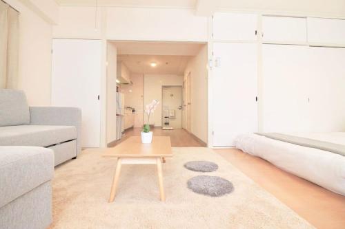 a living room with a coffee table and a couch at Earls Court by b hotel - Spacious & Relaxing just 4 blocks to Peace Park in Hiroshima