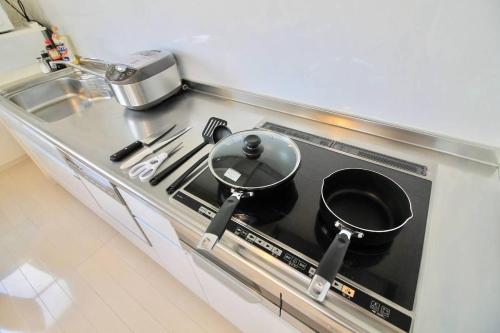 a pot on top of a stove in a kitchen at Luxes - 10 min Hiroshima Station & 2BR Up to 10p in Hiroshima