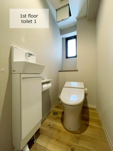 a small bathroom with a toilet and a sink at bHOTEL M's lea - Spacious 2 level apartment 4BR for 16 PPL in Hiroshima