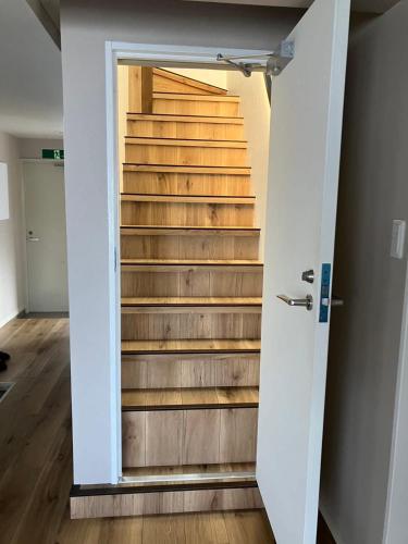 a door leading up to a set of stairs at bHOTEL M's lea - Spacious 2 level apartment 4BR for 16 PPL in Hiroshima